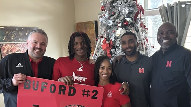 Mario Buford with his parents and coaches Matt Rhule and Evan Cooper.